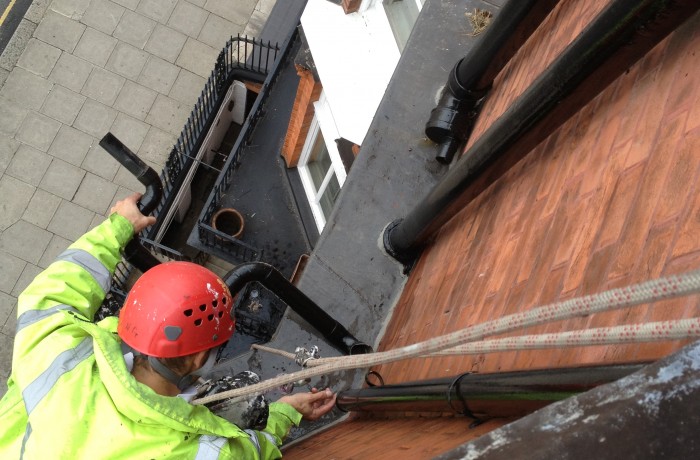 Clearing and repairing a blocked down pipe – London